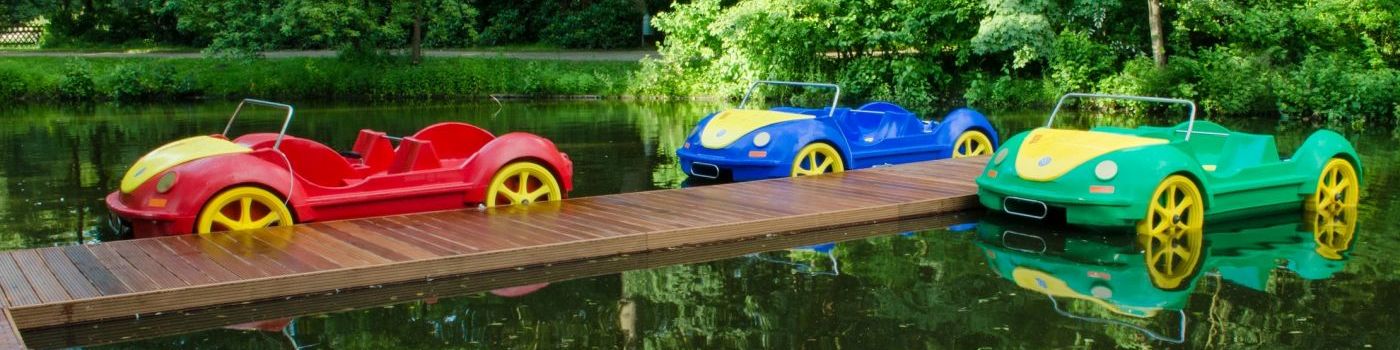 Pedal boats look like cars lie on a mooring.