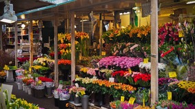 Various flowers on a stand.