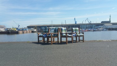 Chairs stand on the quay.