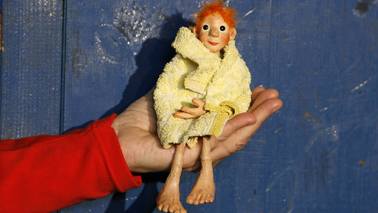  A small figure sitting on a hand.