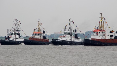Four tugs on the water