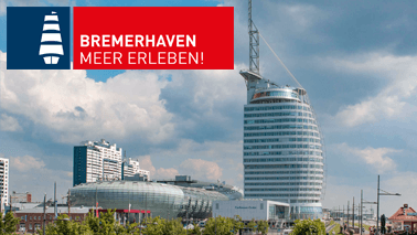 A view from the »Zoo am Meer« towards the Bremerhaven »Havenwelten« including Bremerhaven brand: White ship on a dark blue background next to it a white lettering »Bremerhaven Meer Erleben« on a red background