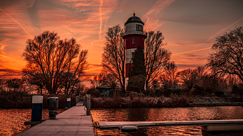 A lighthouse in the sunset
