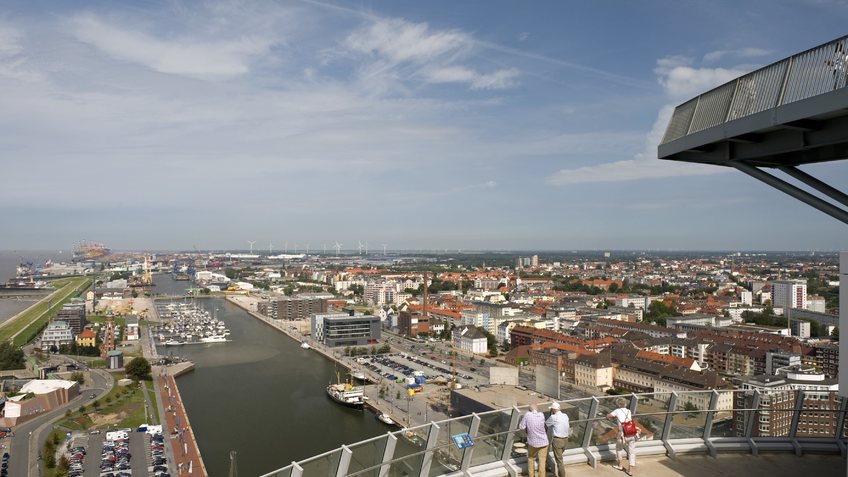  People standing on the viewing platform and look over the city.