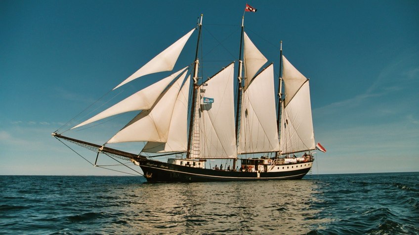 Sailboat with set sails.