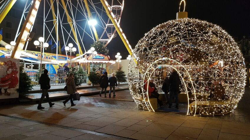 An illuminated bauble at a Christmas market.