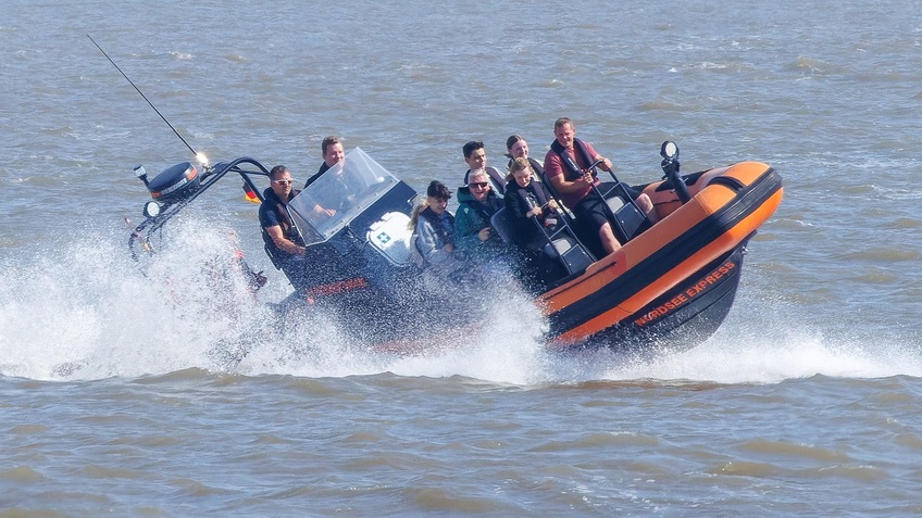 An inflatable boat with passengers.