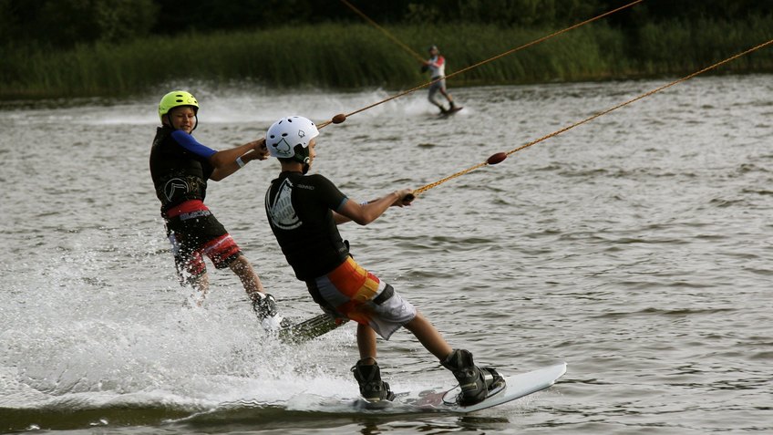 Two water ski rider on a lake.