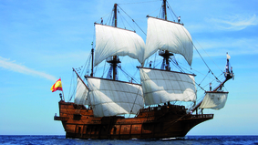  A ship under full sail on the water.