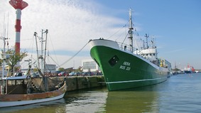 A museum ship lies on a quay.
