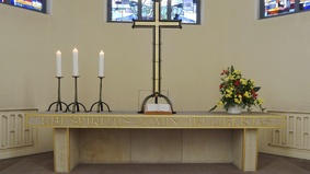 An altar with cross and candles.