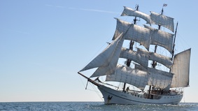 A sailing ship with set sails.