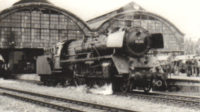 Historical shot of a railway station with locomotive.