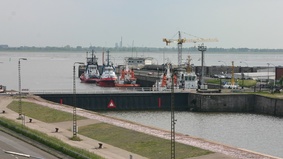 A lock and tug are lying on the quayside.