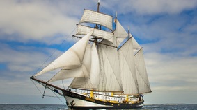 A sailing ship with set sails 