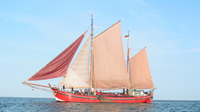 A sailboat with set sails.