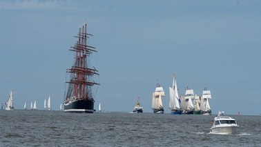 Several sailing ships are sailing