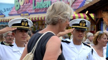Woman leaves the ship. Two cadets greet