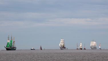 Several sailing ships on water