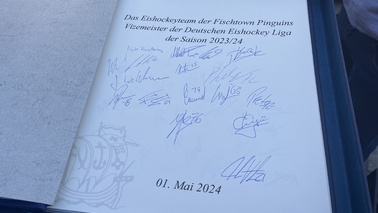 Die Spieler der Fischtown Pinguins unterschrieben im Goldenen Buch der Stadt mit ihren jeweiligen Rückennummern. 