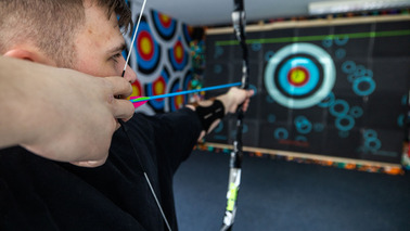 A man takes aim with a bow 