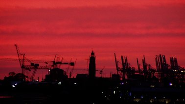 Container cranes at sunset.