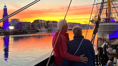 A couple on a ship at sunset 