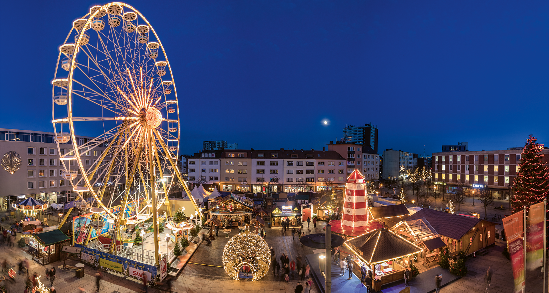A Christmas market with stalls.